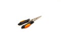 Closed black stainless steel fishing pliers with orange rubber handgrip isolated on white
