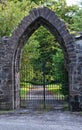 Closed stone arched gate to driveway