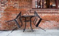 Closed table for two in an outdoor seating area at an urban restaurant. Royalty Free Stock Photo