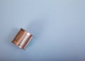 The closed tin can of canned food lies on a blue background. Top view. Copy spaes Royalty Free Stock Photo