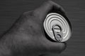 Closed tin can with open key in hand Royalty Free Stock Photo