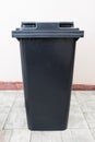 Closed trash can near the wal Royalty Free Stock Photo