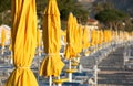 Closed umbrellas and chairs on a bathing Royalty Free Stock Photo