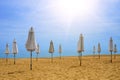 Closed umbrellas on a deserted beach. Close-up. Royalty Free Stock Photo