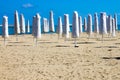 Closed umbrellas in an empty beach Royalty Free Stock Photo