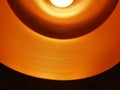 Closed up of black orange ceiling lamp with energy saving fluorescent light bulb Royalty Free Stock Photo