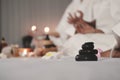 Closed up on black stone and hand women for yoga meditation for create concentration and calm the mind on bed preparing for