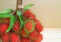 Closed up bunch of ripe Rambutan fruits on wooden table, with free space for design Royalty Free Stock Photo