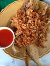 Closed up the dish of fried fish with chilli sauce