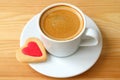 Closed up espresso coffee with heart shaped cookies served on wooden table Royalty Free Stock Photo