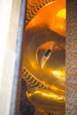 Closed up face from window of Reclining Buddha gold statue. Wat Pho Royalty Free Stock Photo