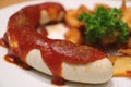 Closed up German white sausage with curry ketchup and fried potatoes Royalty Free Stock Photo