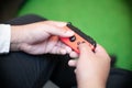 Closed Up Of Guy`s Hands Playing On The Red Game Console. A Wireless Console Controller. Enjoying Free Time Concept. Preoccupied