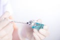 Closed up hand of Nurse fills syringe from injection vial Royalty Free Stock Photo