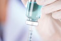 Closed up hand of Nurse fills syringe from injection vial on white Royalty Free Stock Photo