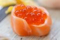 Closed-Up Ikura Salmon Roe Sushi Wraped with Salmon. Royalty Free Stock Photo