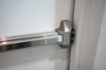 Closed up latch and door handle of emergency exit. Push bar and