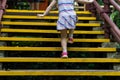 Closed up little girl climbing up stairs outdoors