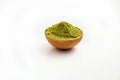 Closed up macro object, Isolate heap of extracted Green Tea Powder in wooden bowl on white background. This is best natural ingre