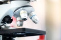 Closed up of microscope in the laboratory with orange light and blurred background. Royalty Free Stock Photo