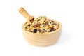 Closed up mixed dry organic cereal and grain seed pile in wooden spoon and scoop on white background
