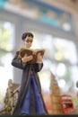 A closed up photo of Harry Potter figure is reading a spell book.