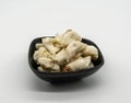 Closed up premium jumbo lump of fresh blue crab meat in small black ceramic bowl isolated on white