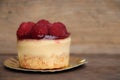 Closed up Raspberry cheese cake sweet bake and beautiful topping of  fruit on wood background Royalty Free Stock Photo