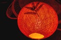 Closed up red color of velvet paper lantern and bamboo leaf Royalty Free Stock Photo