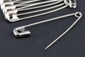 Closed-up shiny metal open safety pin on black background Royalty Free Stock Photo