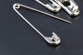 Closed-up shiny metal open safety pin on black background Royalty Free Stock Photo