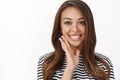 Closed-up shot tender and feminine coquettish woman with freckles, smiling happily, touch jawline and gazing camera