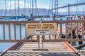 Closed-up of a signage with no tresspassing signages on a wooden dock at San Francisco, CA