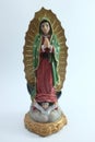 Small Figure Statue of Blessed Virgin Mary in Roman Catholic Church on white background. Royalty Free Stock Photo