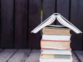 Closed up stack of books with wooden background Royalty Free Stock Photo