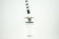 Closed up syringe put on cap of vial Royalty Free Stock Photo