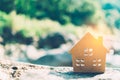 Closed up tiny home model on floor or wood board with sunlight green bokeh background. Deam life have own house property for Royalty Free Stock Photo