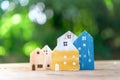 Closed up tiny home model on floor or wood board with sunlight green bokeh background. House property for living or investment Royalty Free Stock Photo