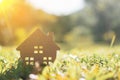 Closed up tiny home model on green grass with sunlight.