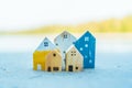 Closed up tiny home models on sand with sunlight and beach Royalty Free Stock Photo