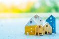 Closed up tiny home models on sand with sunlight and beach Royalty Free Stock Photo