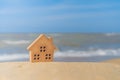 Closed up tiny home models on sand with sunlight and beach Royalty Free Stock Photo