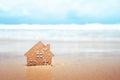 Closed up tiny home models on sand with sunlight and beach Royalty Free Stock Photo