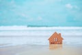 Closed up tiny home models on sand with sunlight and beach Royalty Free Stock Photo