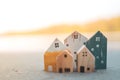 Closed up tiny home models on sand with sunlight and beach Royalty Free Stock Photo