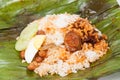 Closed up of the unwrapped original nasi lemak on banana leaf.