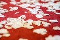 Closed up white flower petals on red carpet floor in church at C
