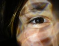 Closed up of a woman eye with light effect on her face