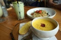 Yellow pumpkin soup with garlic bread serving on the timber block