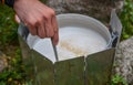 Closed view of hand stir porridge in a pan